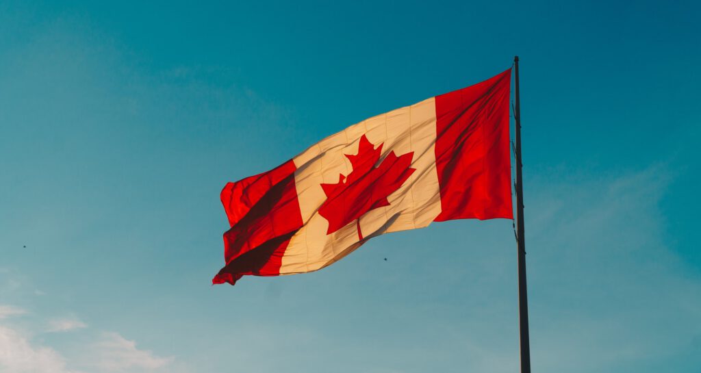 The Canadian flag against a blue sky