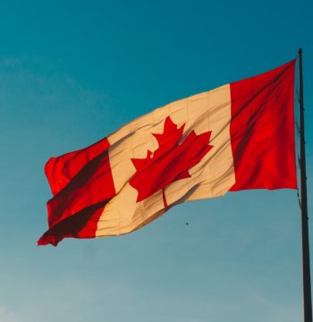 The Canadian flag against a blue sky