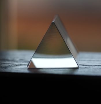A glass triangle representing the fraud triangle