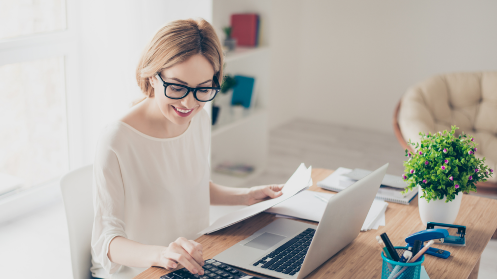 An image of a small business owner working on her computer in her home office.