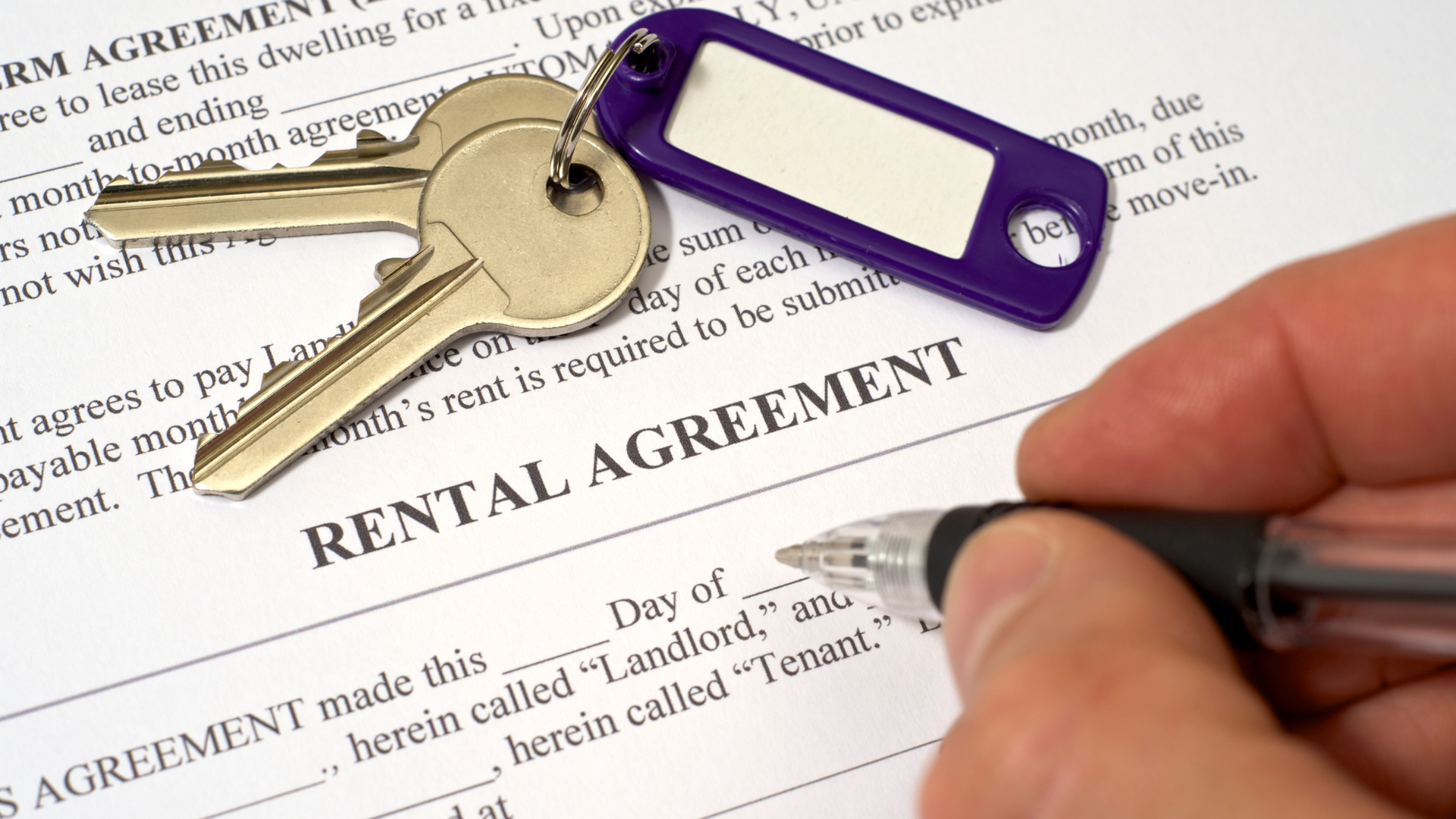 An image of a small business owner signing rental agreement documents