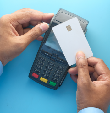 An image of a small to medium size business owner using his credit card.
