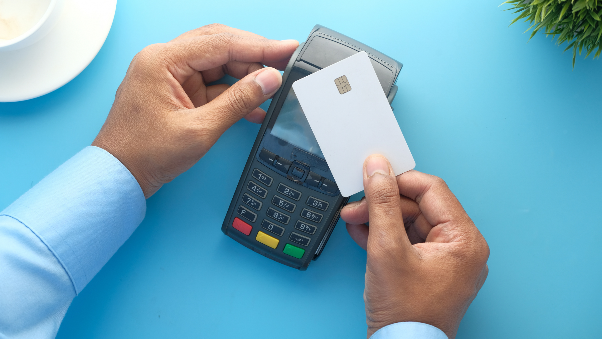An image of a small to medium size business owner using his credit card.