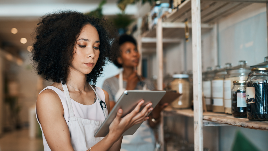 An image of a small business owner in Burlington Ontario, reviewing her taxes on a tablet.