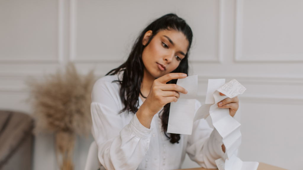 An image of a small business owner in Burlington Ontario reviewing her business receipts