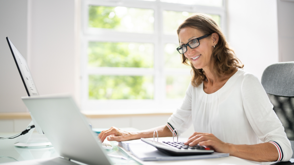 An image of a small business bookkeeper working in her home office.