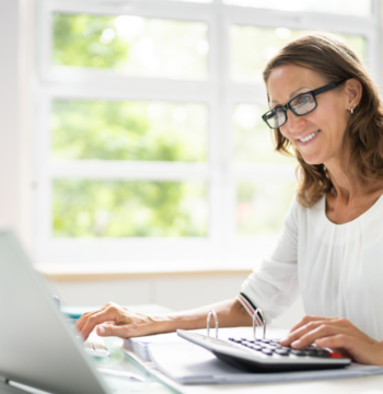 An image of a small business bookkeeper working in her home office.