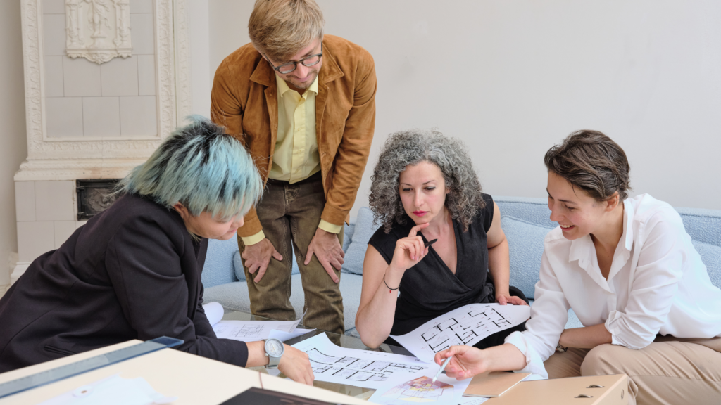 An image of a small business owner in a team meeting with their staff.