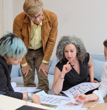 An image of a small business owner in a team meeting with their staff.