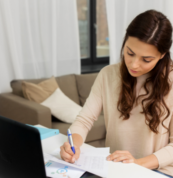 An image of a small business bookkeeper reviewing her client records.