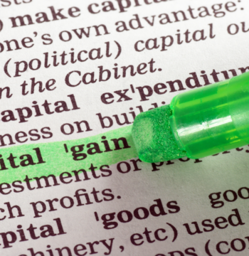 An image of a highligher with the term capital gain highlighed in green ink.