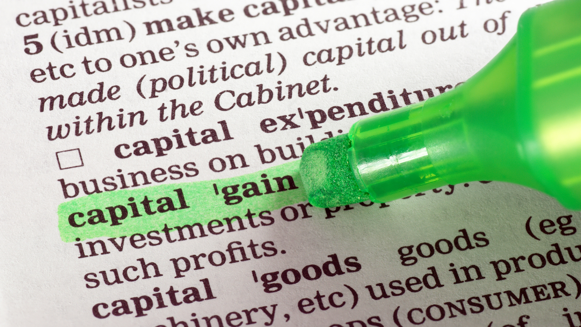 An image of a highligher with the term capital gain highlighed in green ink.