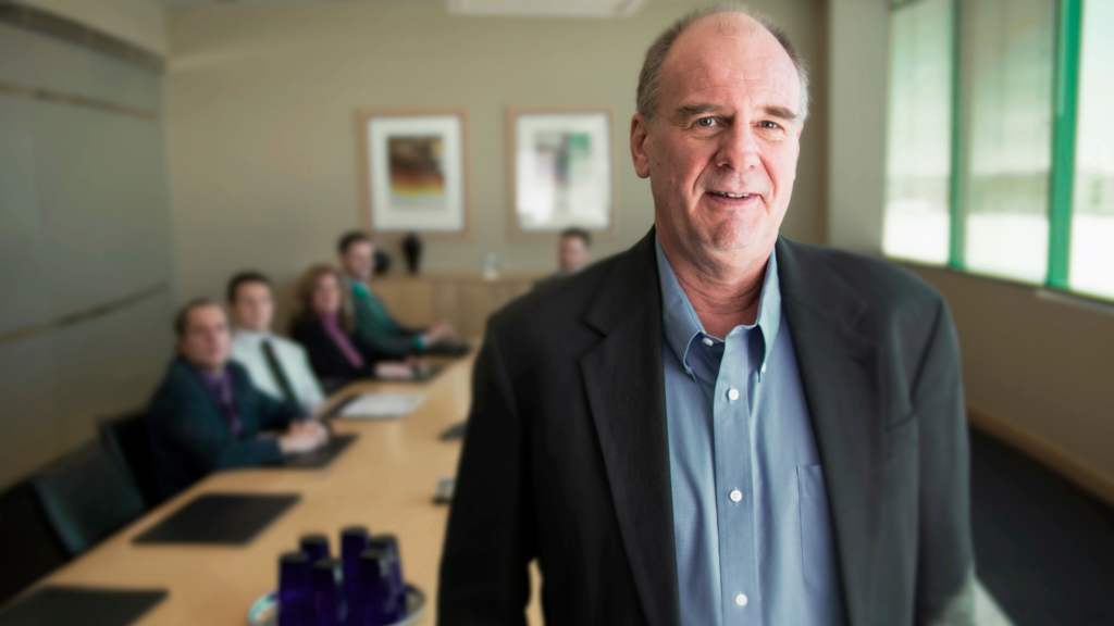 An image of a fractional CFO that is meeting with his clients to help them with their business finances.