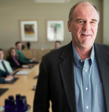 An image of a fractional CFO that is meeting with his clients to help them with their business finances.