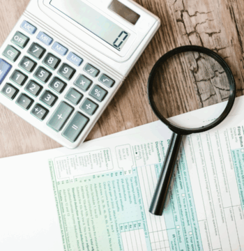 An image of a cross border tax advisory in Burlington with several US tax forms ready to be filled in with their client.