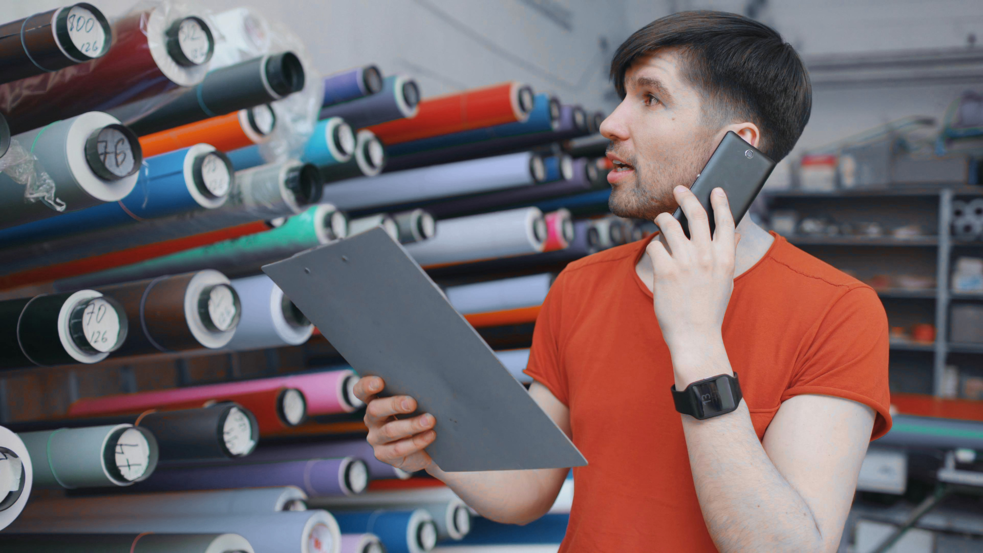 An image of a small business owner in Burlington who is on the phone with one of his suppliers.